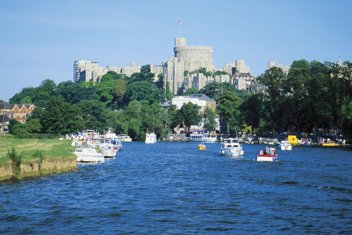 Rivers - The Image shows boats on the River Thames outside Windsor Castle, England UK